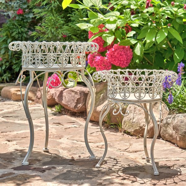 Two plant stands made of iron in color antique white side by side