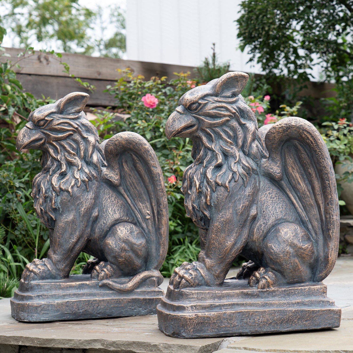 these statues boast intricate sculpted details, including lifelike feathers, a fierce beak, and powerful claws. Each piece is hand-painted in a distressed finish, offering a timeless, weathered look.