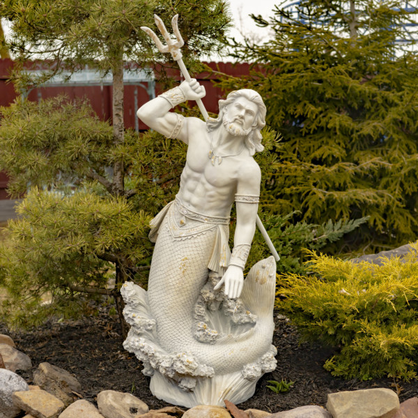 Tall antique grey merman statue with his muscular body throwing a trident