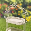 Close up image of the first tier of the Antique White Plant Stand showing you the curlicue design at the top of the item