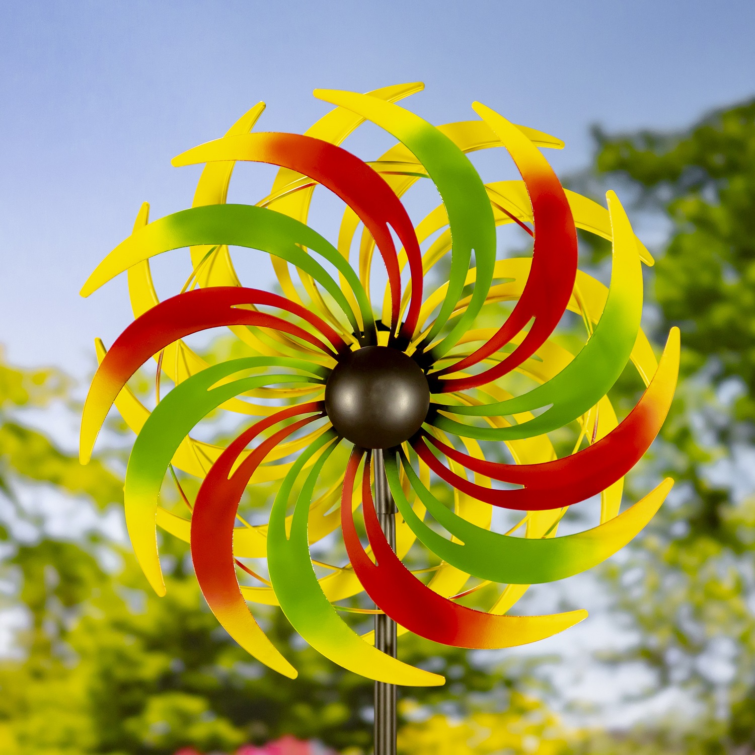 The iron windmill blades are each hand painted in vibrant alternating green and red, gradating into yellow