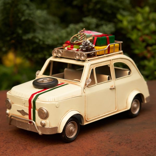 1980 Vintage Creamy Colored Car with a spare tire on the hood and Christmas Gifts on the roof of the car tabletop decor