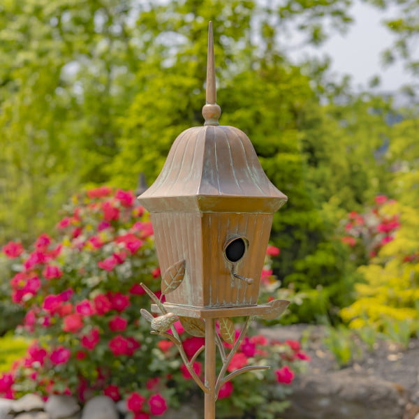 closed up image of iron birdhouse stake in antique copper hand-painted distressed finish with patina details with bell roof and little bird perched on decorative leaf