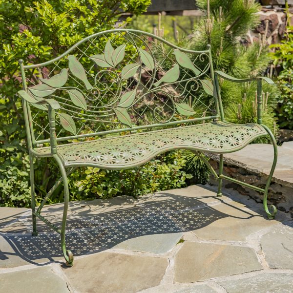 Classic iron garden bench with lattice backrest and engraved perched birds on leaves in antique green distressed finish