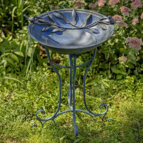 full length image taken from birdseye view of 31 inch Tall Two Birds Iron Birdbath in Frosted Blue outside in garden