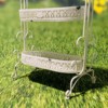 Close up image of the bottom of the Antique White Plant Stand showing you the detailed design around ever tier