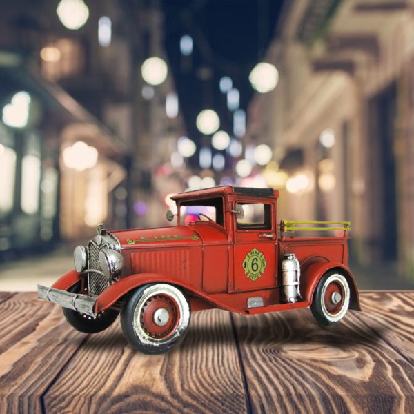 Metal Red Fire Truck with Gold Emblem and Silver Rims sitting on a Table Top