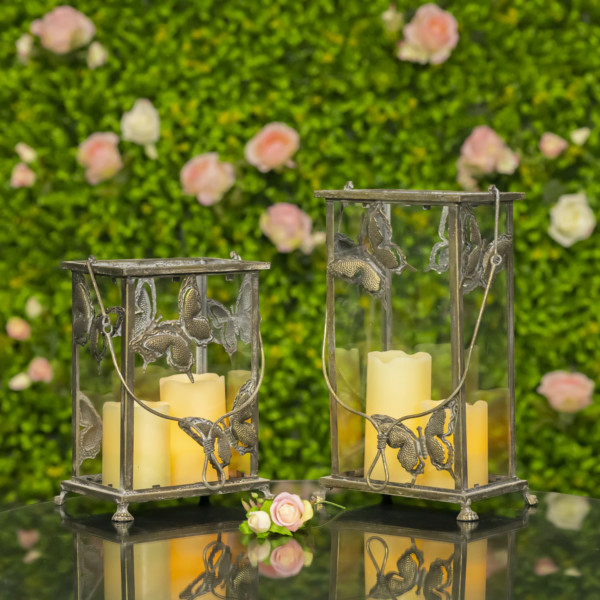 One small and one large frosted gold lantern with butterfly design with candle lit in it ( Candles not included )