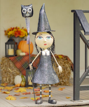 Halloween decoration of Tall Metal Big eye witch girl wearing a black dress and pointed hat holding a stake