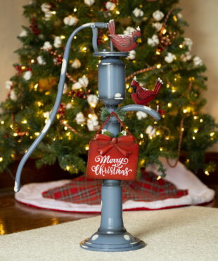 31 inch tall old style iron Christmas water pump in antique blue finish and faux snow patches with Merry Christmas sign and red cardinals