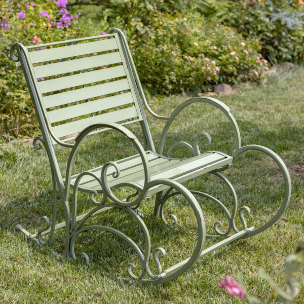 Antique Green iron rocking arm chair with curlicue dedigns on the side