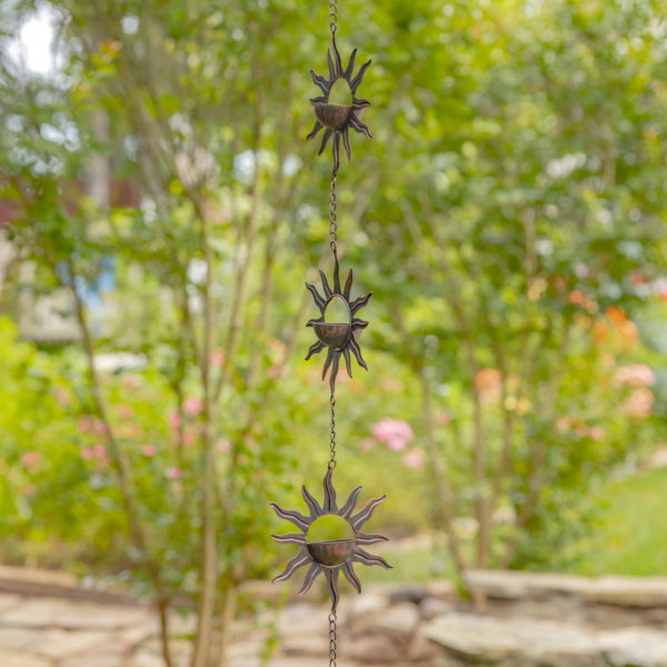 View of Three Suns and Moons Hanging from a Metal Chain