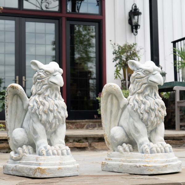 these statues boast intricate sculpted details, including lifelike feathers, a fierce beak, and powerful claws. Each piece is hand-painted in a distressed finish, offering a timeless, weathered look.