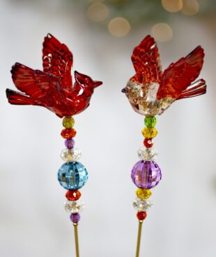 Two Birds Sitting on a Stick with Pink and Blue Beads