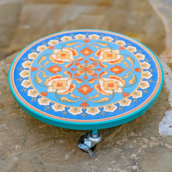 Flat round plant trolley with mosaic tiling in colors teal and orange