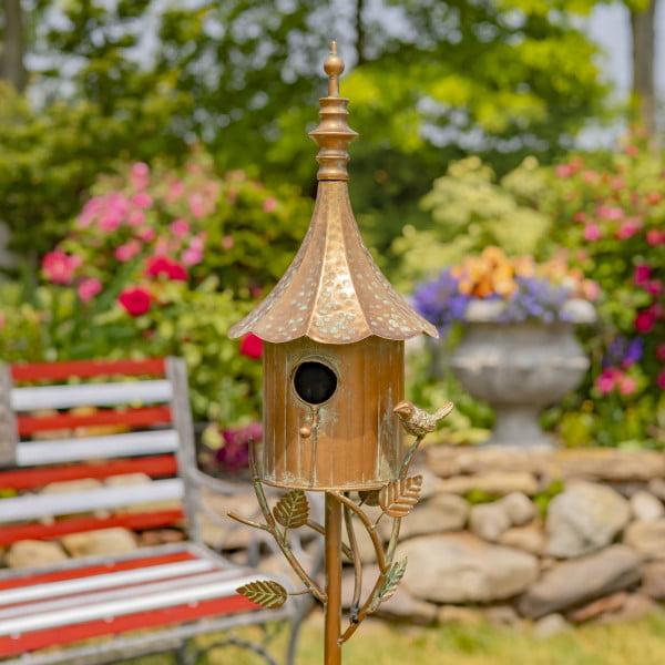 closed up image of iron birdhouse stake in antique copper hand-painted distressed finish with patina details with cone roof and little bird perched on decorative leaf
