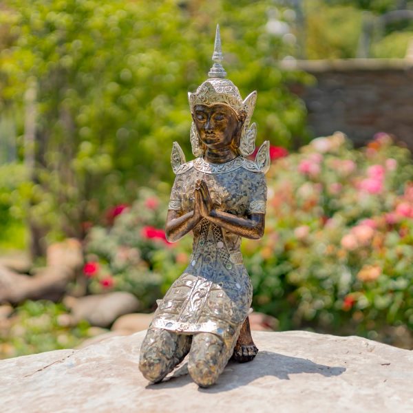 Thai Buddha kneeling in Prayer Statue in garden