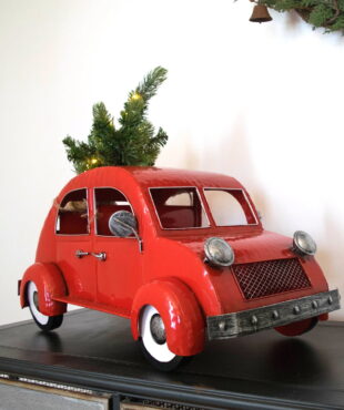 vintage style metal glossy red car with Christmas tree on top