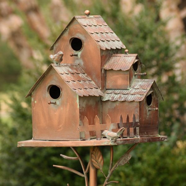 Metal Birdhouse Sitting on a Stake with Birds