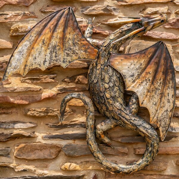 Metal wall dragon with a gold and black finish