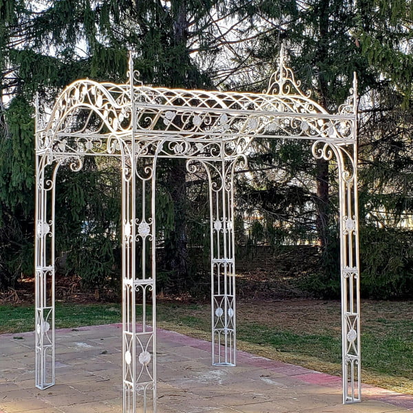 diagonal view 10.5 feet tall rectangular arched iron garden gazebo in antique white distressed finish in garden