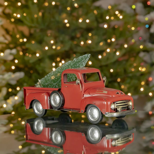 16 inches long classic red vintage iron pick up with Christmas tree in trunk on a tabletop