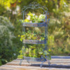 Full image of the Antique Blue three tier Plant Stand with curlicue designs at the top, sides and bottom of the item