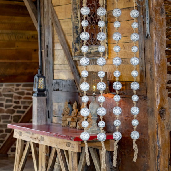 image of 4 74 inch long hanging rope garland with ceramic sailor balls in 2 sizes with floral ornaments in white, grey and black colors