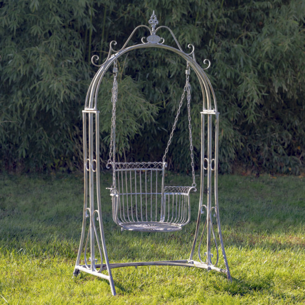 Large blue bronze iron swing chair with curlicue designs to the top of the swing and a neatly deigned chair with four iron chains holding it up