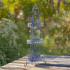 Side view of the Antique Blue three tier Plant Stand with curlicue designs at the top, sides and bottom of the item