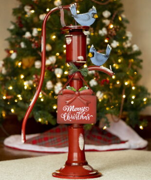 31 inch tall old style iron Christmas water pump in antique red finish and faux snow patches with Merry Christmas sign and bluebirds