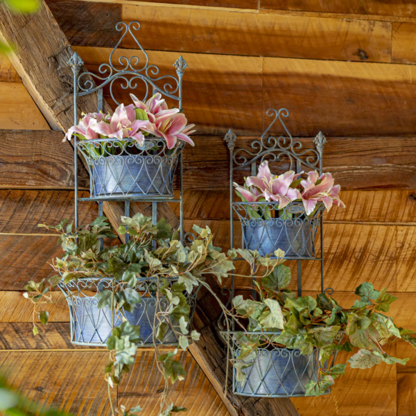 One set of blue hanging wall planters with removeable baskets and has curlicue designs on the top and in the two places where the removable baskets goes