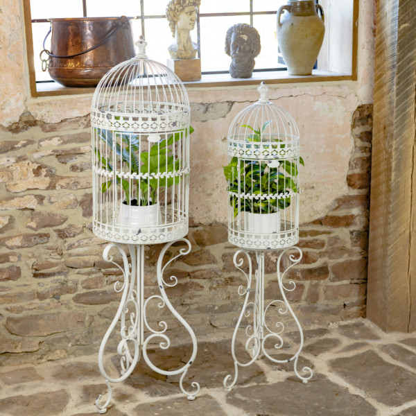 Two Antique White Metal Plant Stand in a Victorian style with folding stands and curlicue structure with plants inside (Plants not included)