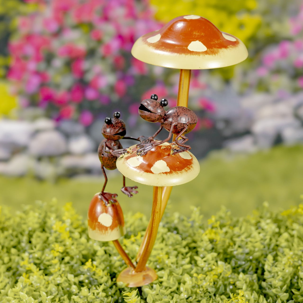 iron garden stake painted in natural colors with 2 friendly frogs helping each other to climb on a mushroom