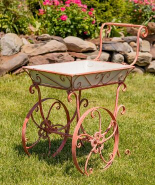 metal flower cart with white removable display bin and distressed hand painted pink iron frame with 2 wheels and handle
