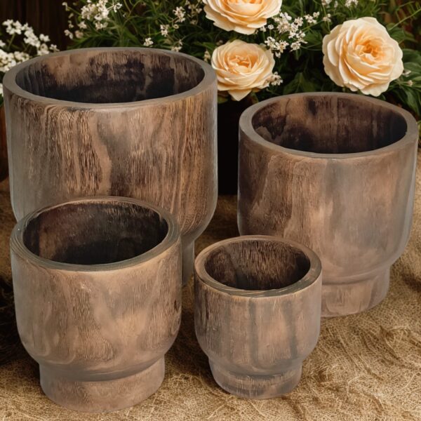 image of four wooden nesting plants with a rustic outdoor background