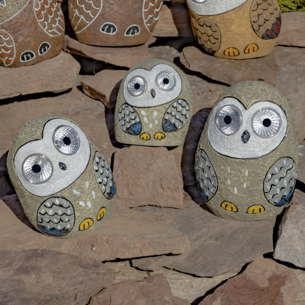 One set of 3 Solar Owls sitting on some rocks in Grey looking at you with there round big eyes that lit up in the dark