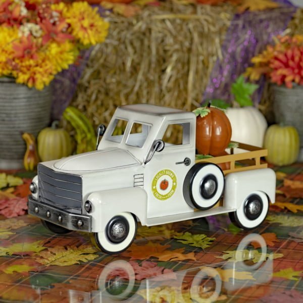 side view of 18 inch long antique white metal pickup truck tabletop decor with pumpkins