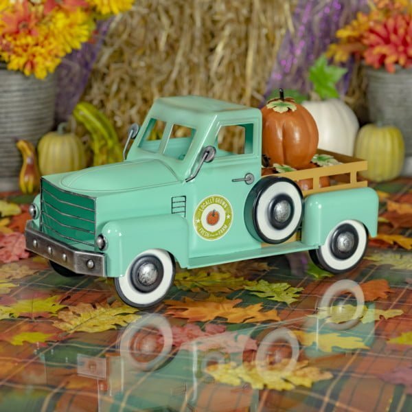 side view of 18 inch long teal metal pickup truck tabletop decor with pumpkins