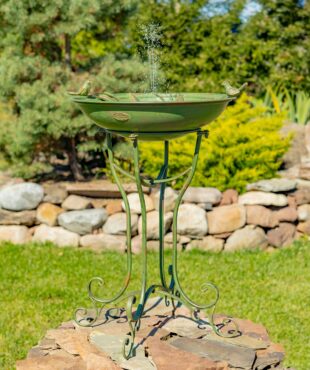 full length image of 31 inch tall iron birdbath with two bird sculpture details perched on basin edge, decorative stand with a distressed hand painted verdi green finish outdoors