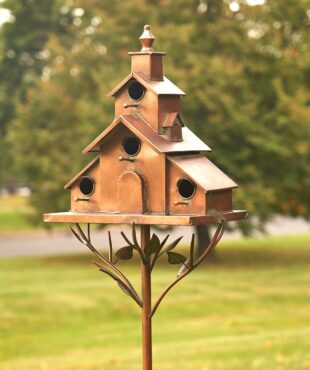 Large iron church style birdhouse stake Dublin standing on branches with leaves