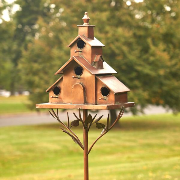 Large iron church style birdhouse stake Dublin standing on branches with leaves