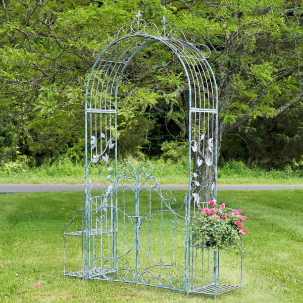 side view image of 8 Feet Tall Iron Garden Gate Arch with side plant stands in antique distressed light blue finish in garden