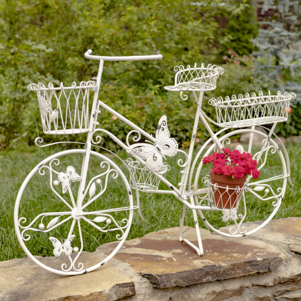 Large white bicycle butterfly plant stand with four baskets attached to the bike with one holding bright red flowers ( Flowers not included)