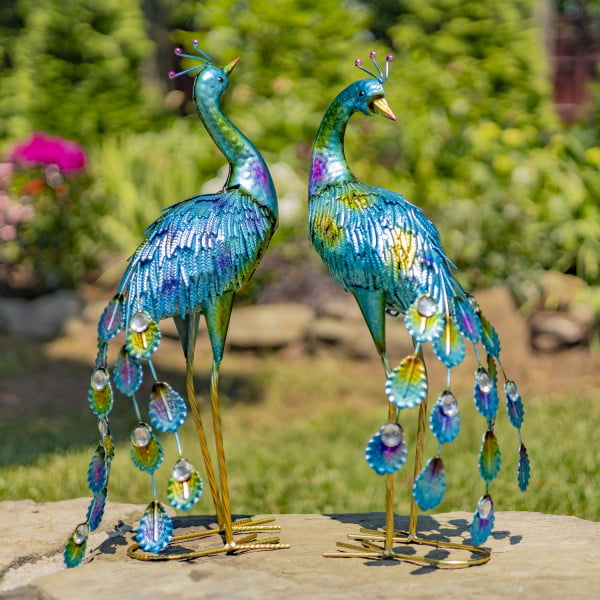 pair of 2 metallic painted iron peacock garden figurines with gems in garden