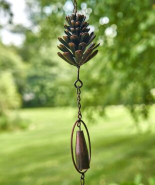 close up 2 sections of antique bronze hanging pinecone and bell rain chain