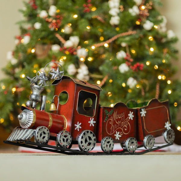 left side of 31 inch long antique red iron Christmas train with snowflake, star, and holly details