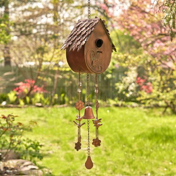 full length image of metal hanging on a chain A-frame birdhouse with round bottom and wind chimes in antique copper finish