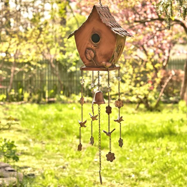 full length image of metal hanging on a chain birdhouse with curved roof and wind chimes in antique copper finish