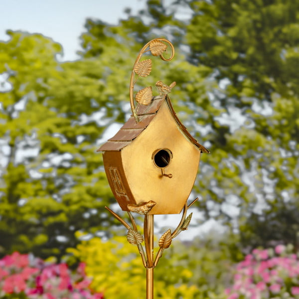 metal birdhouse with curved roof and a little bird perched on it painted in antique copper finish with patina details